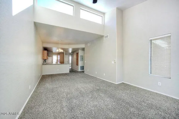 an empty room with windows and closet