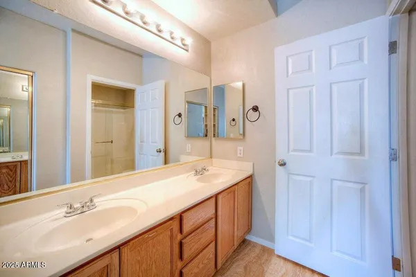 a bathroom with a double vanity sink and a mirror
