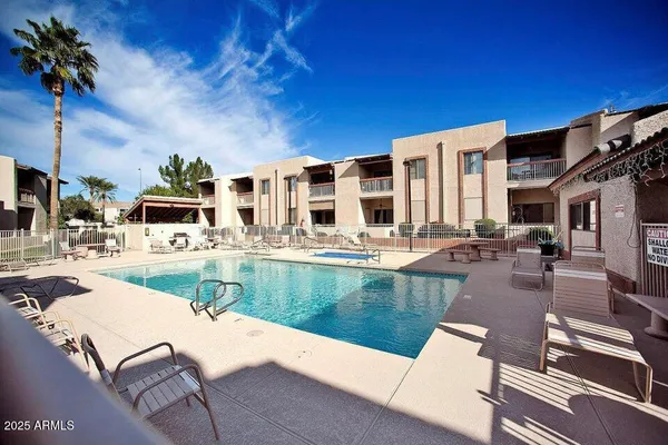 a view of a patio with swimming pool table and chairs