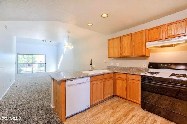 a kitchen with stainless steel appliances granite countertop a sink stove and cabinets