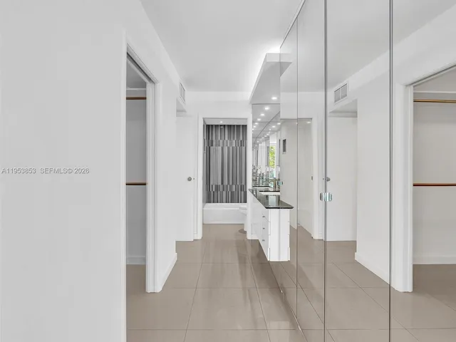 a view of a hallway with wooden shelves