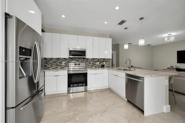 a kitchen with cabinets stainless steel appliances and a counter top space