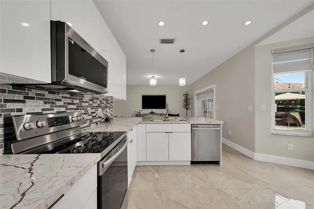 a kitchen with a sink stove and microwave