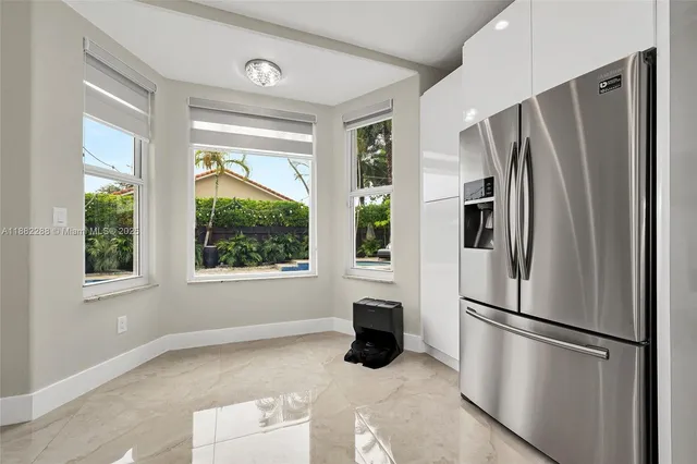 a metallic refrigerator freezer sitting in a kitchen