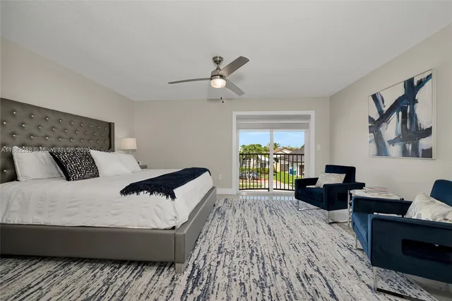 a bedroom with a bed a couch and a window