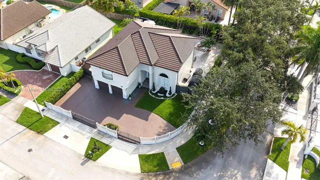 an aerial view of a house with garden space and street view