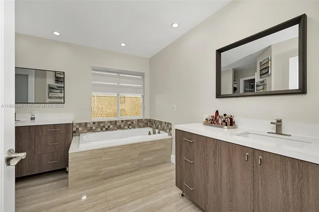 a view of a kitchen with a sink and wooden floor