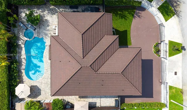 a aerial view of a house with swimming pool and garden