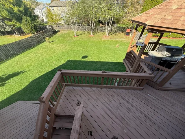 a view of a swimming pool with a garden and deck