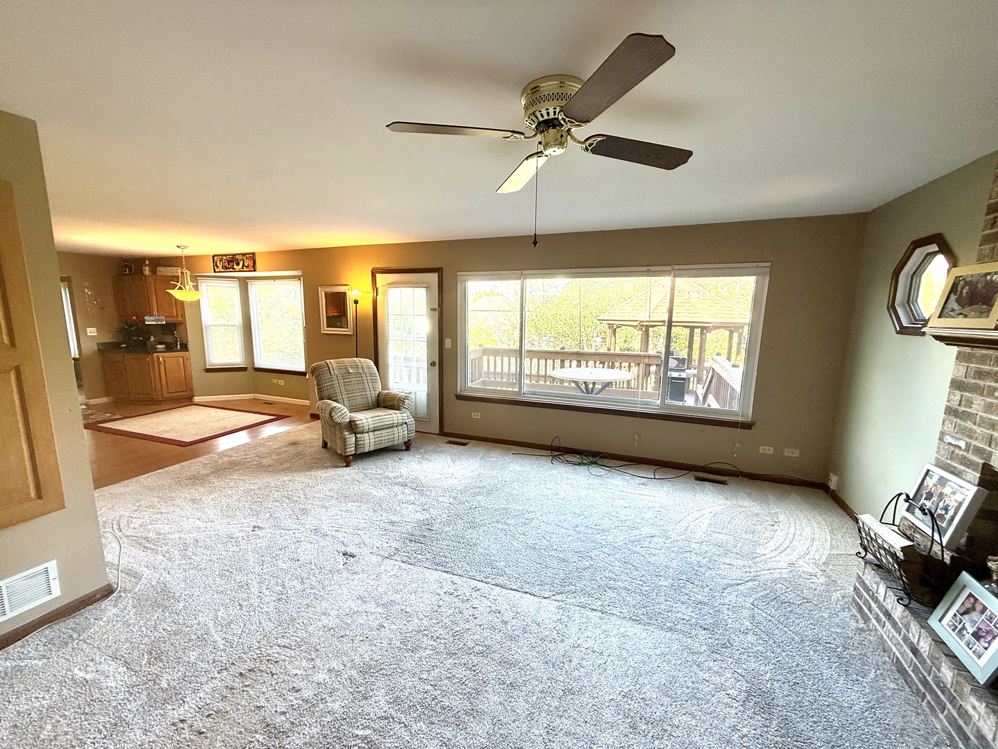 721 Mohican Trail Lake In The Hills, IL 60156 - Photo 3 of 20 a view of a livingroom with furniture hardwood floor and windows