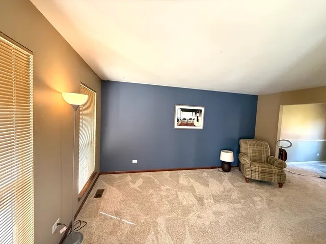 a view of a livingroom with furniture and a window