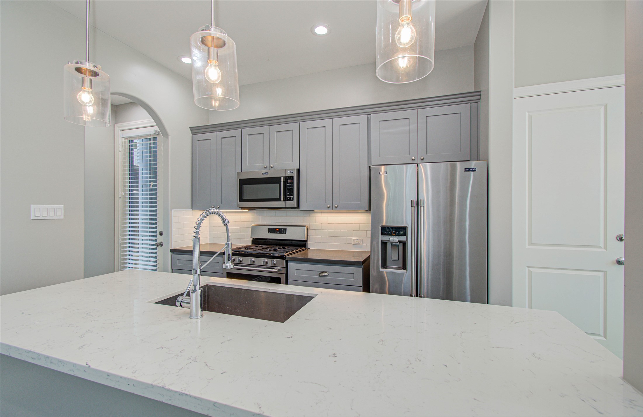 8903 Spring Knoll Forest Drive Houston, TX 77080 - Photo 24 of 29 a kitchen with stainless steel appliances a refrigerator sink and stove