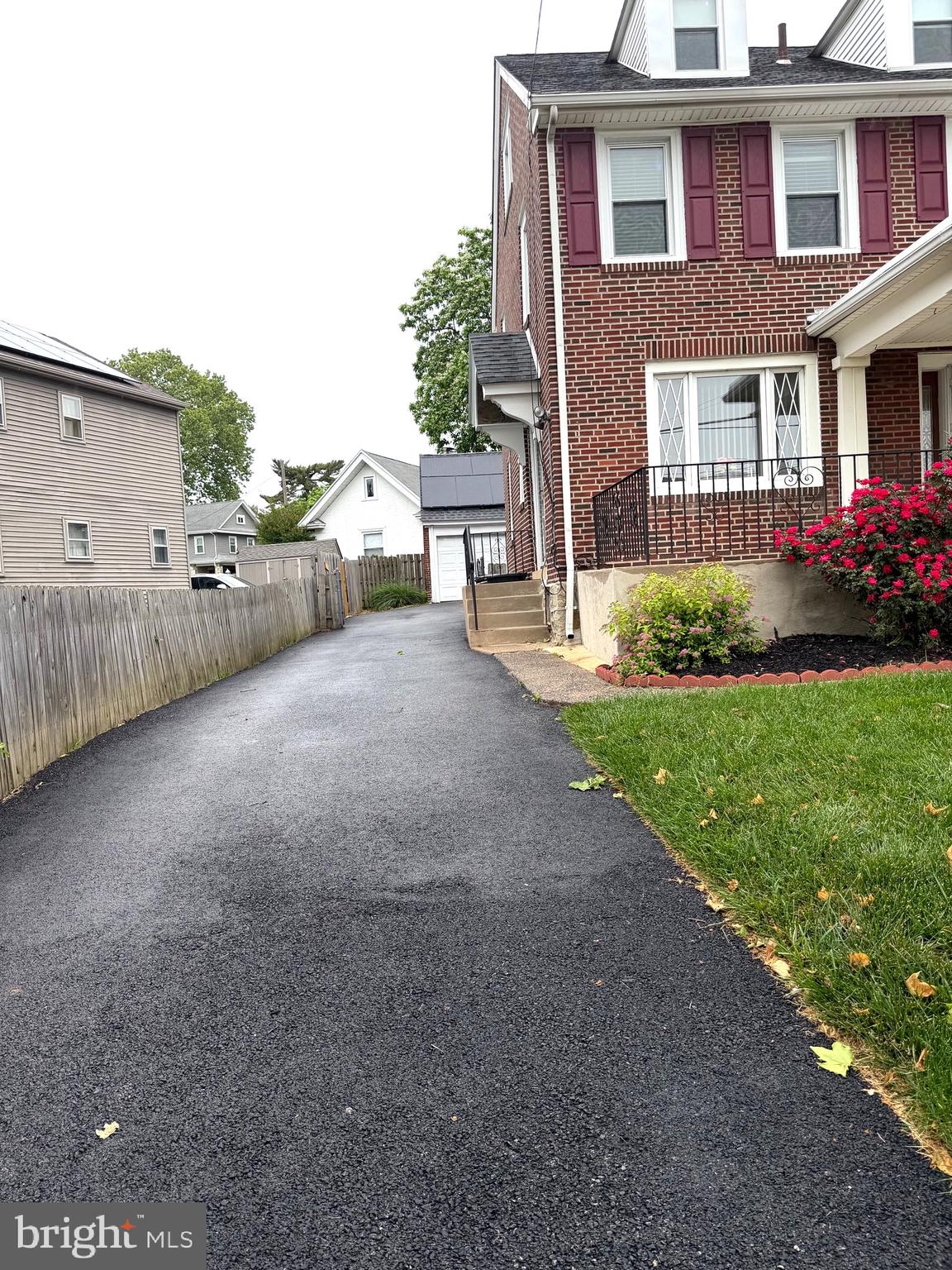463 Burmont Road Drexel Hill, PA 19026 - Photo 2 of 39 a view of a brick house with a yard next to a road