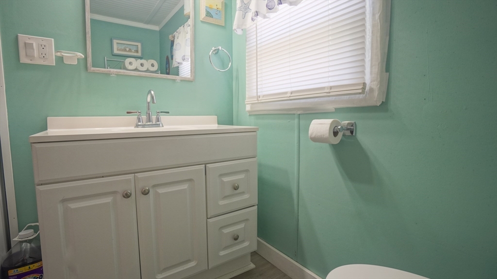 93 Grochmal Avenue, Unit 126 Springfield, MA 01151 - Photo 31 of 35 a bathroom with a sink mirror and toilet
