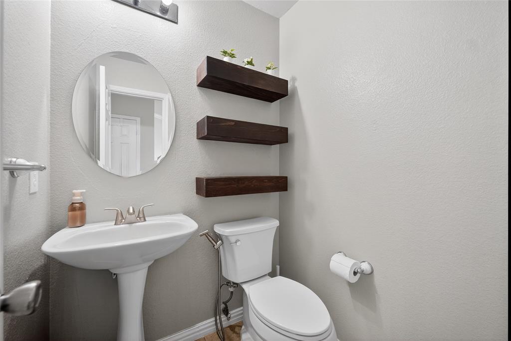 9633 Anns Way Plano, TX 75025 - Photo 31 of 37 a bathroom with a toilet sink and mirror