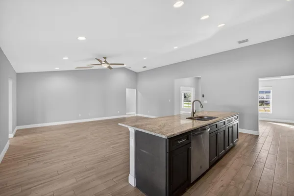 a kitchen with stainless steel appliances a refrigerator and a stove top oven