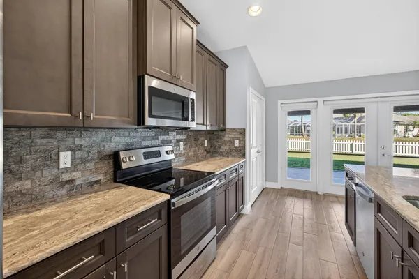 a view of kitchen with refrigerator and window