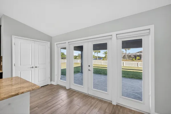 an empty room with wooden floor and window