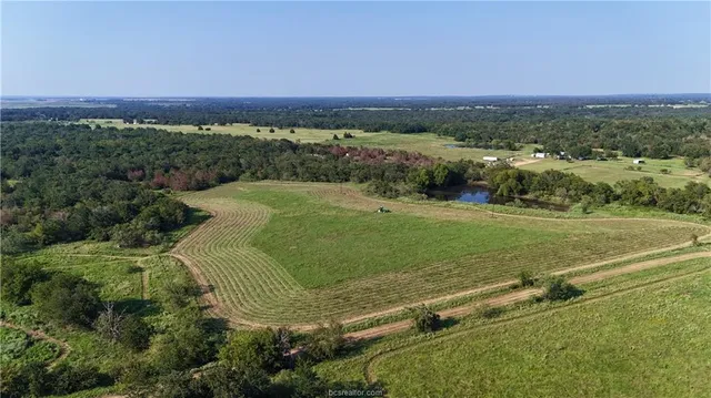 an aerial view of a golf course with a lake view