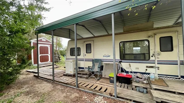 a view of a chairs and table in the back yard