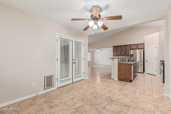 a view of kitchen with refrigerator and microwave