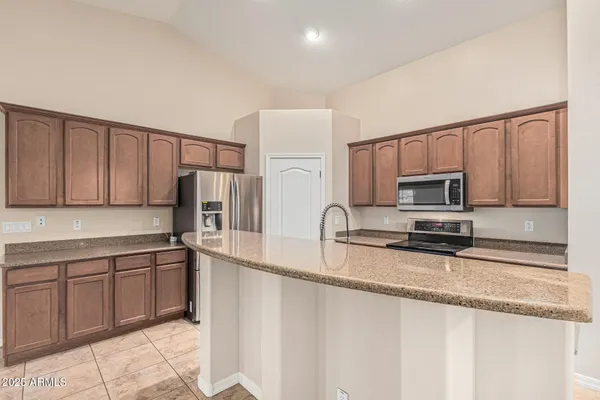 a kitchen with stainless steel appliances granite countertop a refrigerator sink and cabinets