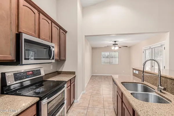 a kitchen with granite countertop a stove and a microwave