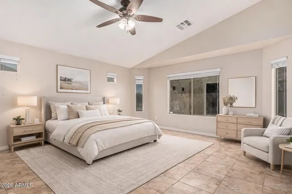 a bedroom with a large bed and a window