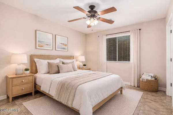 a bedroom with a large bed and a chandelier