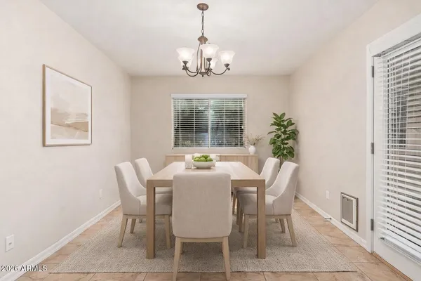 a dining room with furniture and window