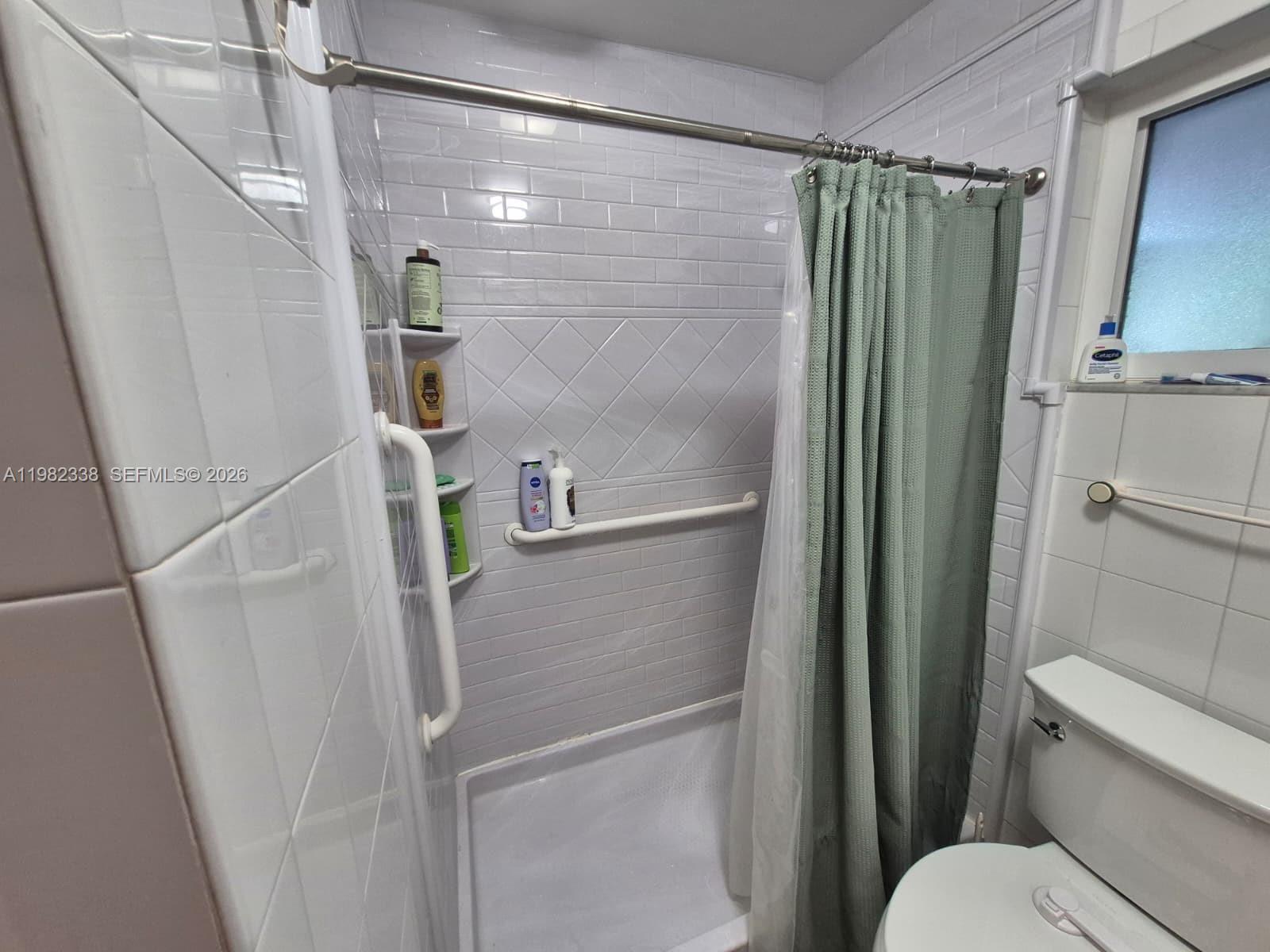 14530 Southwest 110th Street Miami, FL 33186 - Photo 29 of 45 a bathroom with a shower and toilet
