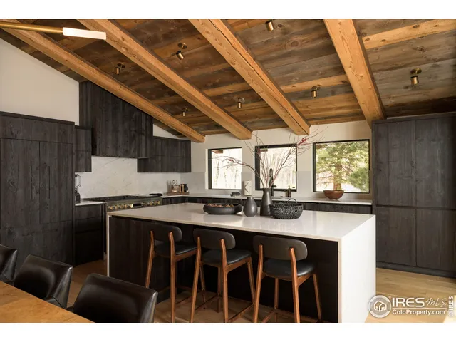 a kitchen with a sink a stove a refrigerator and cabinets