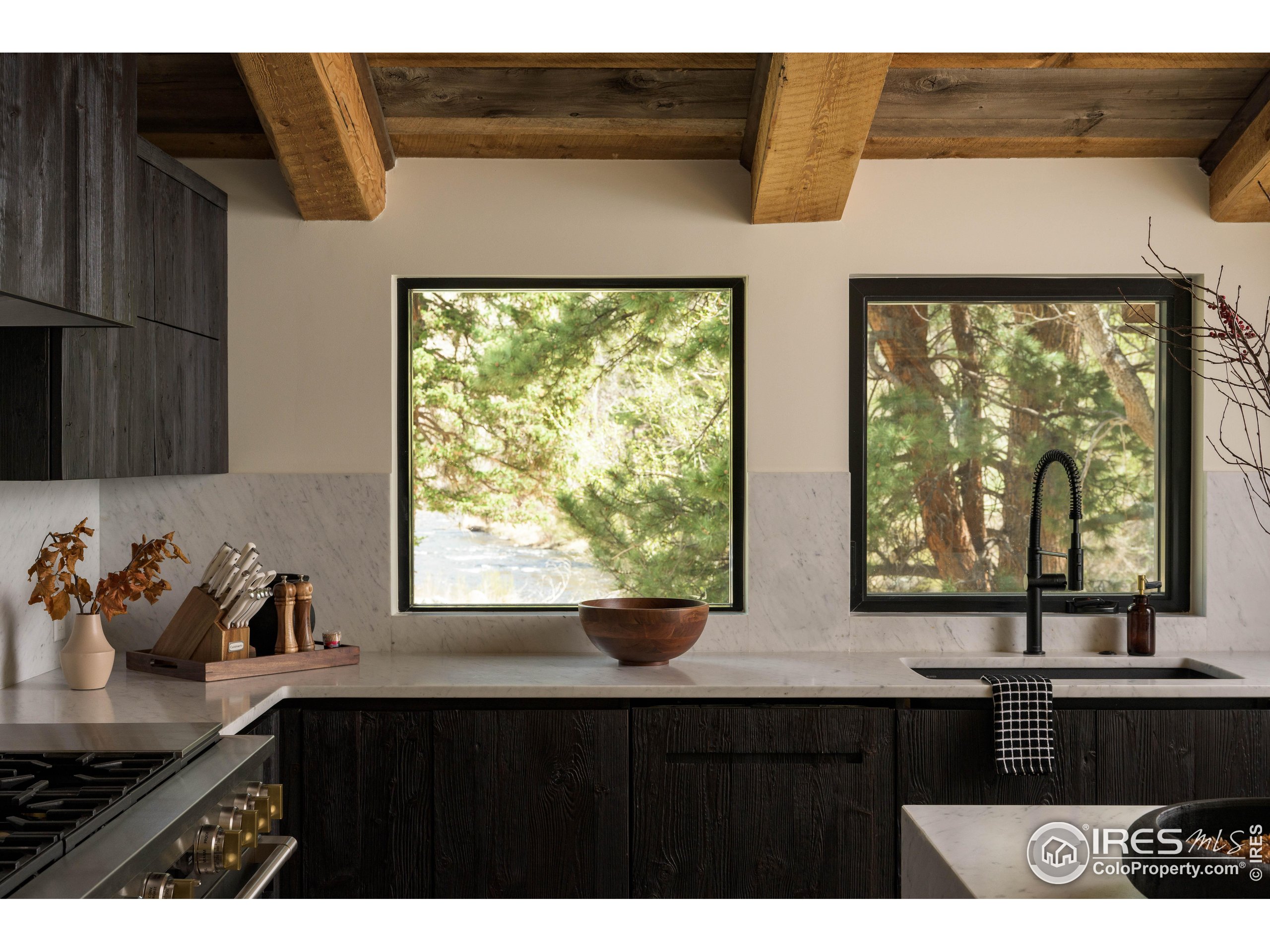 37797 W Highway Bellvue, CO 80512 - Photo 13 of 40 a kitchen with a window a sink and cabinets