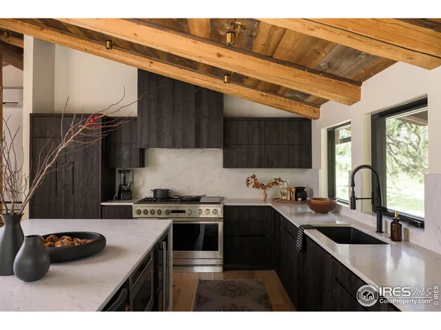 a kitchen with a sink a stove and cabinets