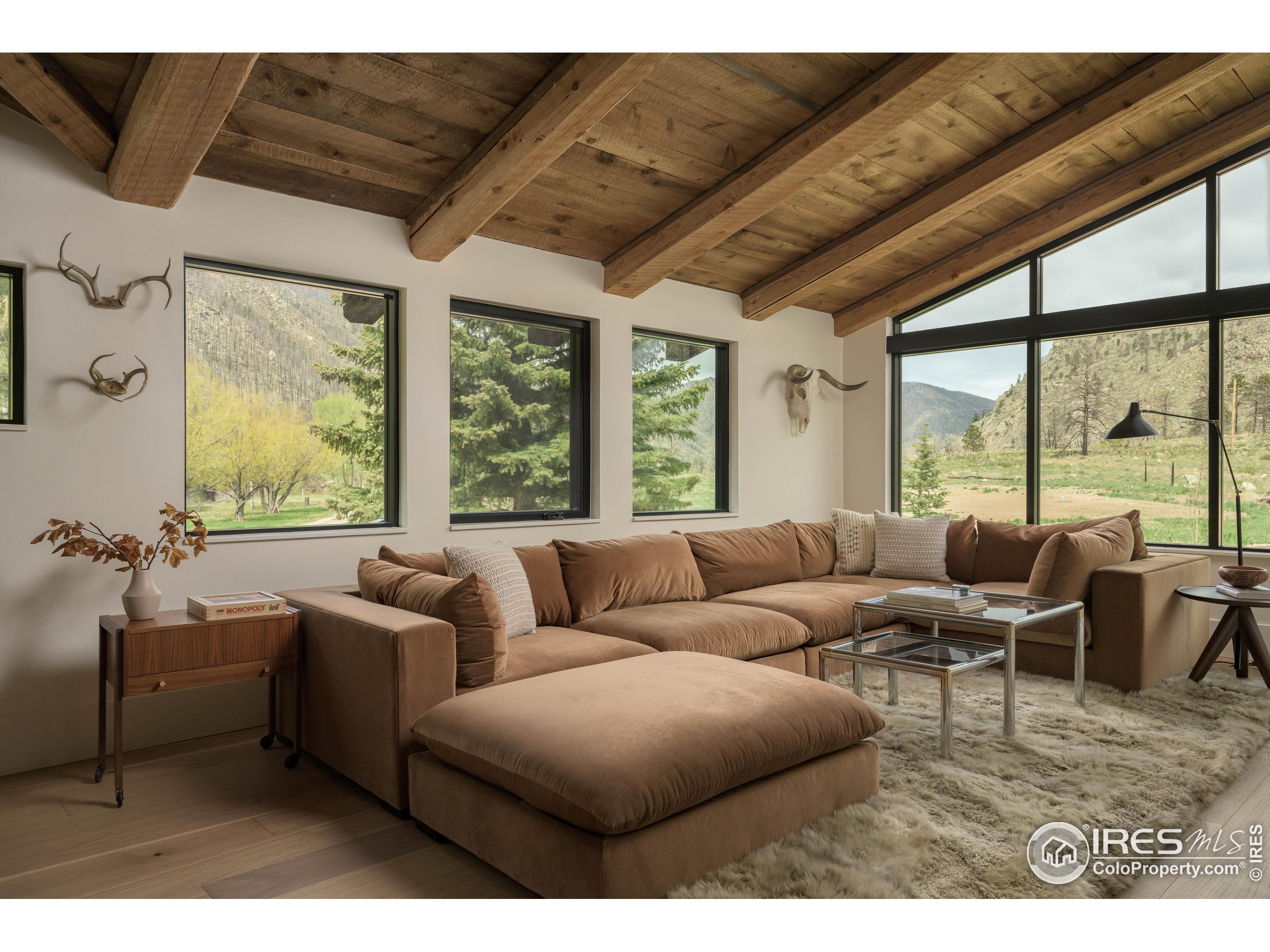 37797 W Highway Bellvue, CO 80512 - Photo 16 of 40 a living room with furniture and a large window