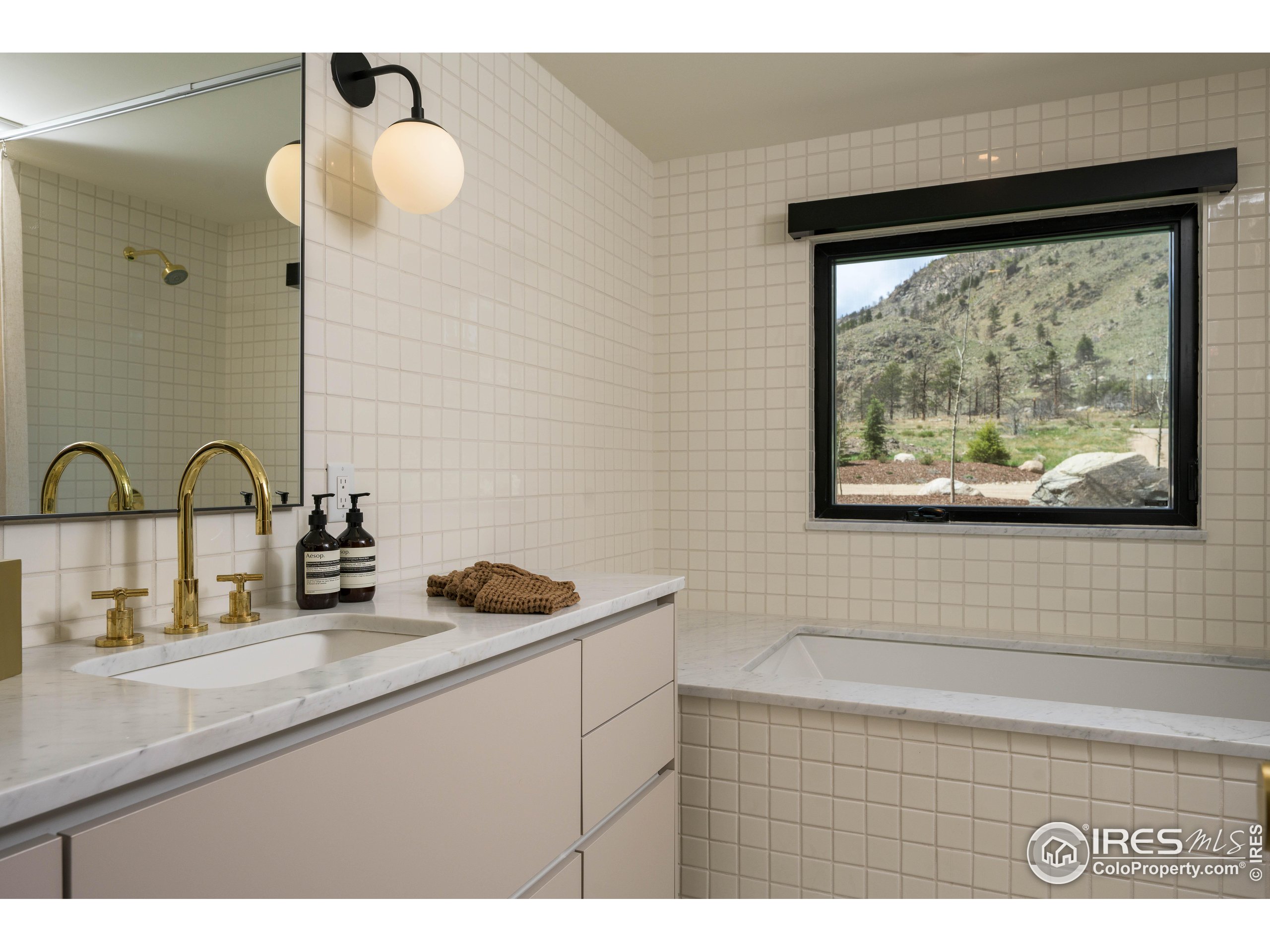 37797 W Highway Bellvue, CO 80512 - Photo 27 of 40 a bathroom with a sink and a large mirror