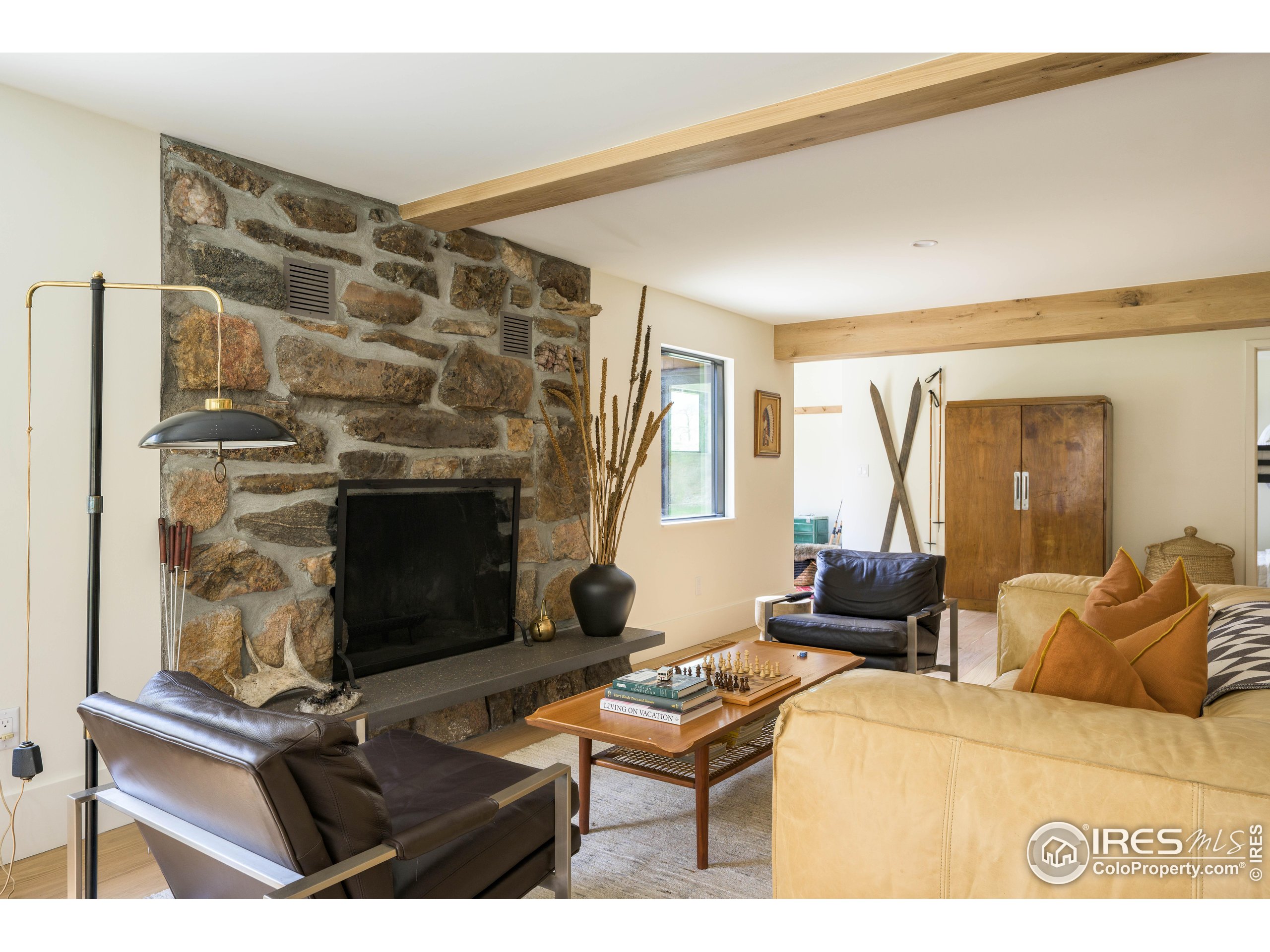 37797 W Highway Bellvue, CO 80512 - Photo 32 of 40 a living room with furniture a flat screen tv and a fireplace