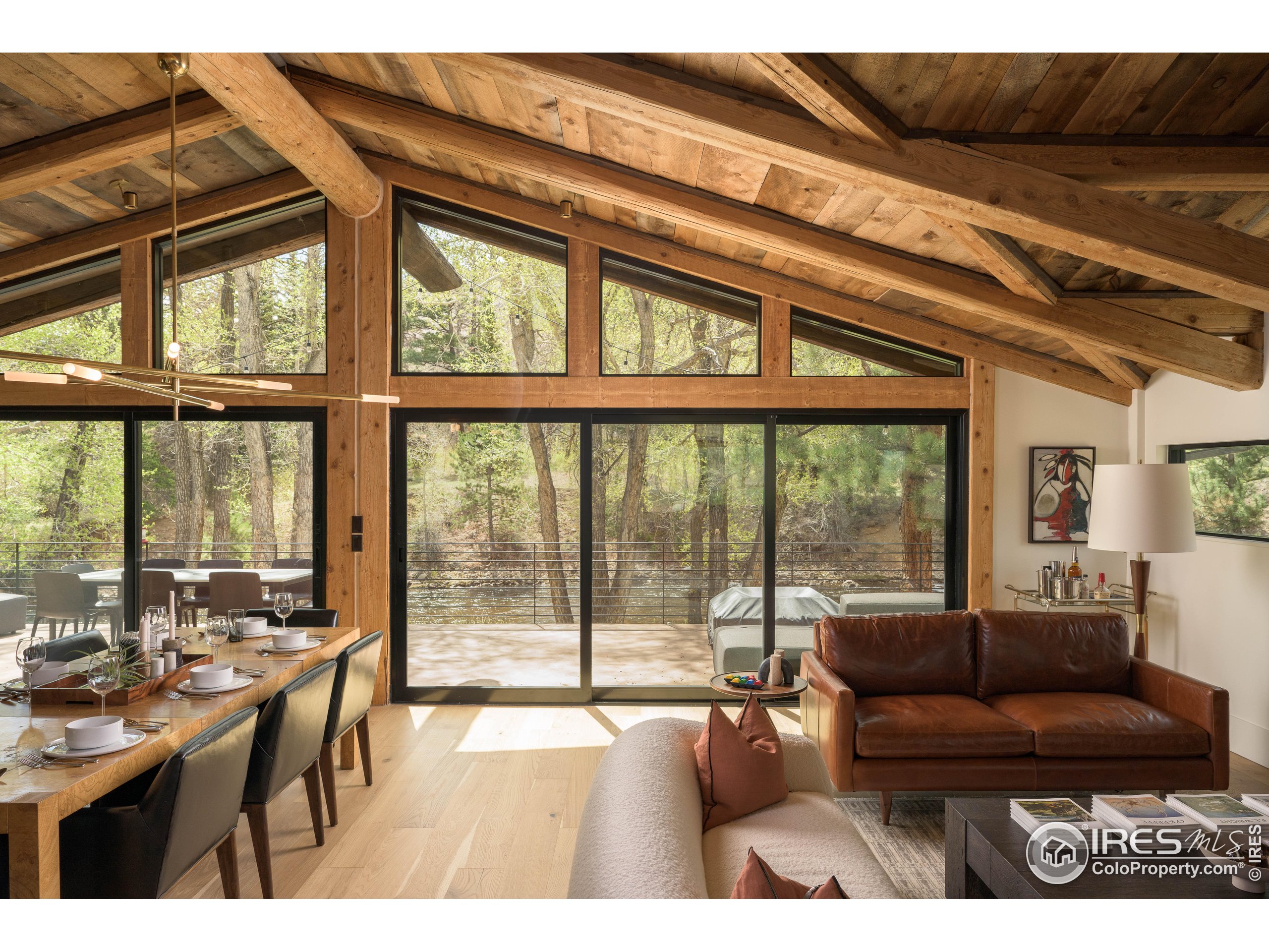 37797 W Highway Bellvue, CO 80512 - Photo 10 of 40 a living room with furniture and a floor to ceiling window