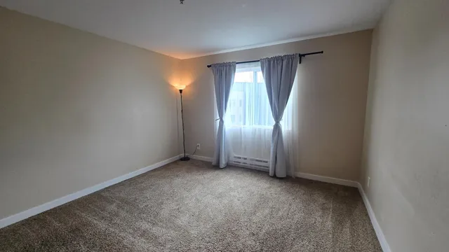an empty room with windows and closet