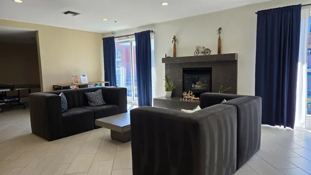 a living room with furniture a fireplace and a flat screen tv