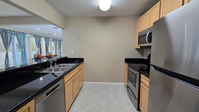 a kitchen with granite countertop a sink and a stove top oven