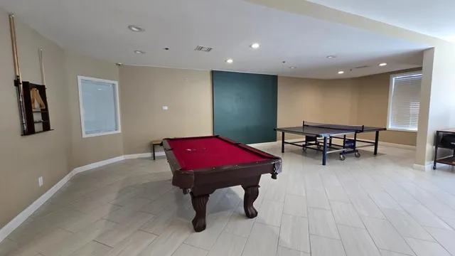 a living room with furniture pool table and a table
