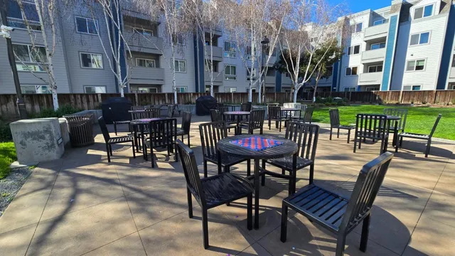 a view of a patio with a table and chairs