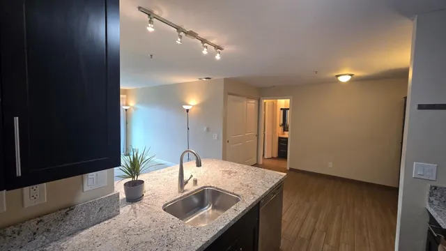 a bathroom with a granite countertop sink a mirror and vanity