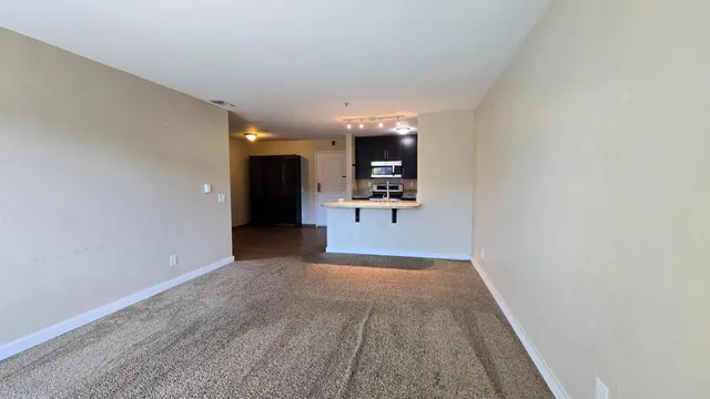 a view of a big room with a kitchen