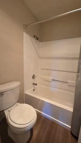 a bathroom with a toilet and a shower
