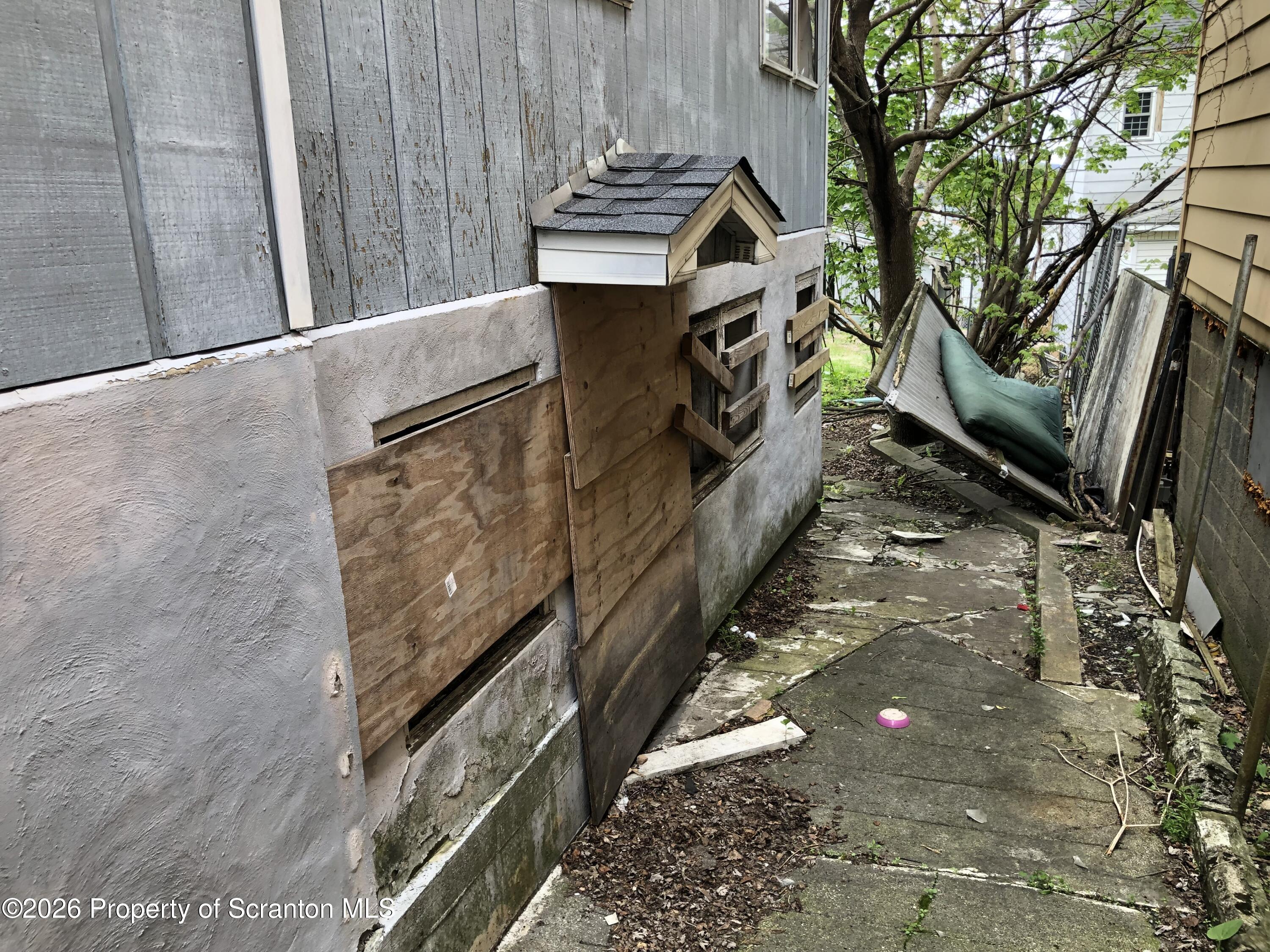 920 Eynon Street Scranton, PA 18504 - Photo 5 of 14 a view of a pathway of a house with wooden fence