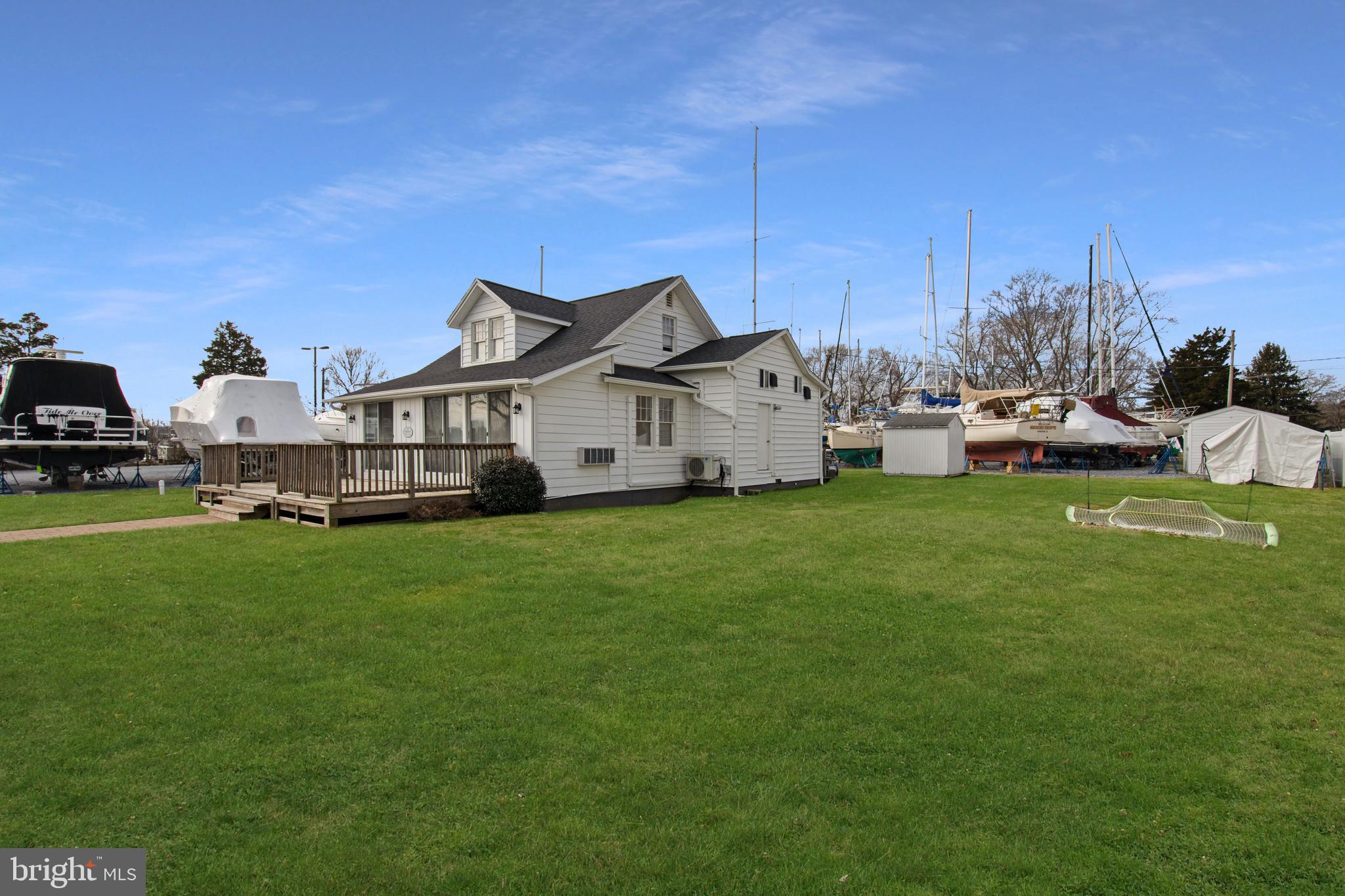 a view of a house with a big yard and sitting area