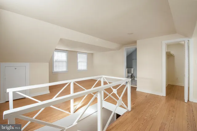 a view of a room with wooden floor and a rug
