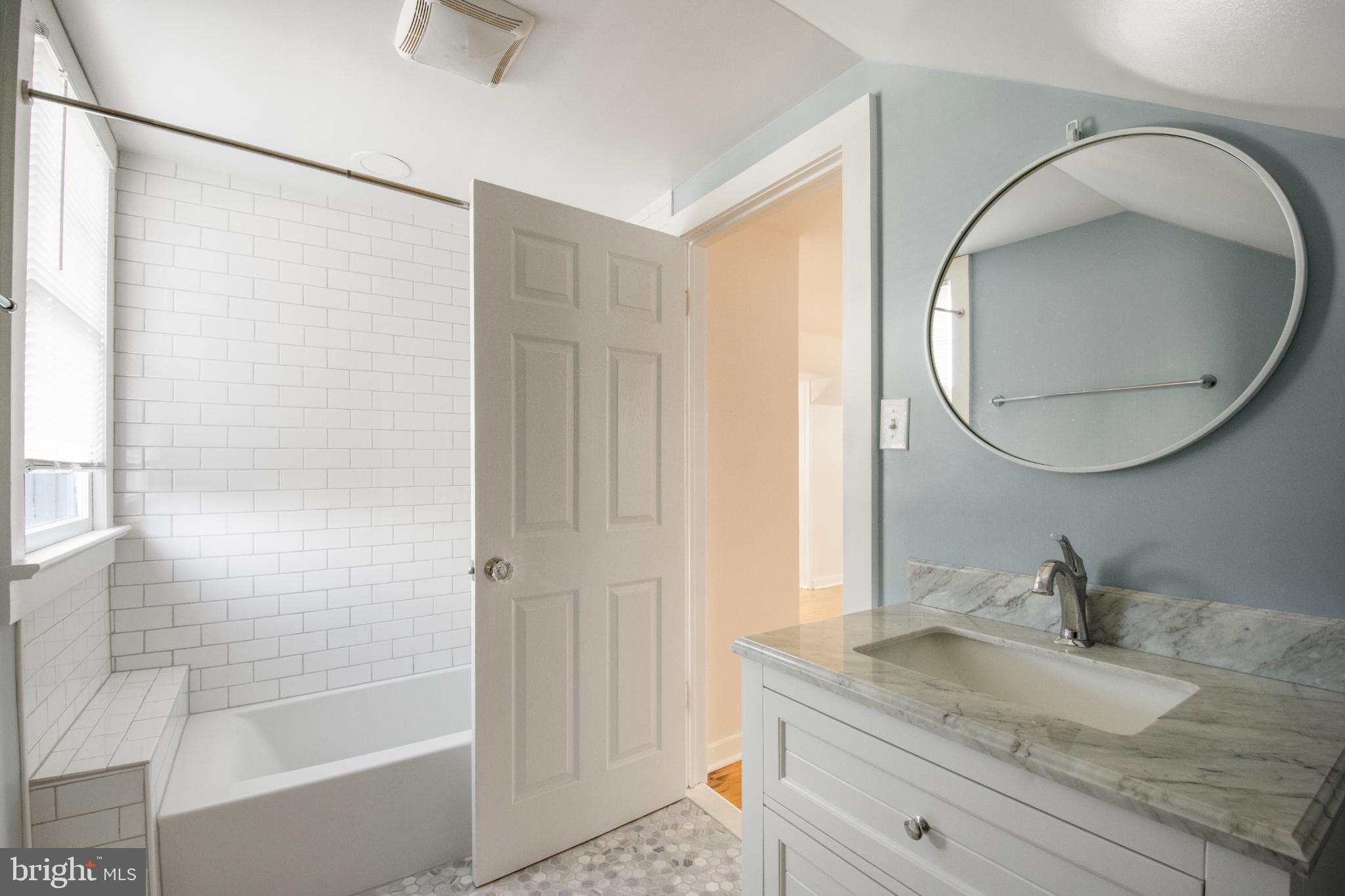 455 Deale Road Deale, MD 20751 - Photo 18 of 20 a bathroom with a granite countertop sink a mirror and shower